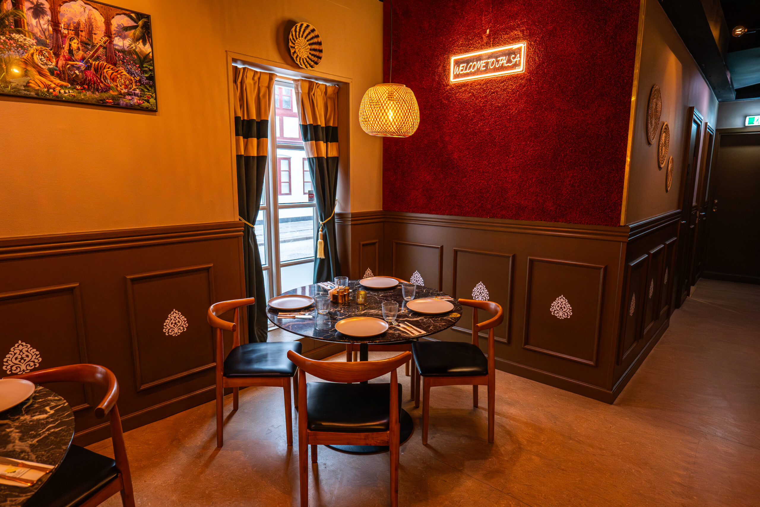 Indisk restaurant, varm indretning, bord til fire personer.